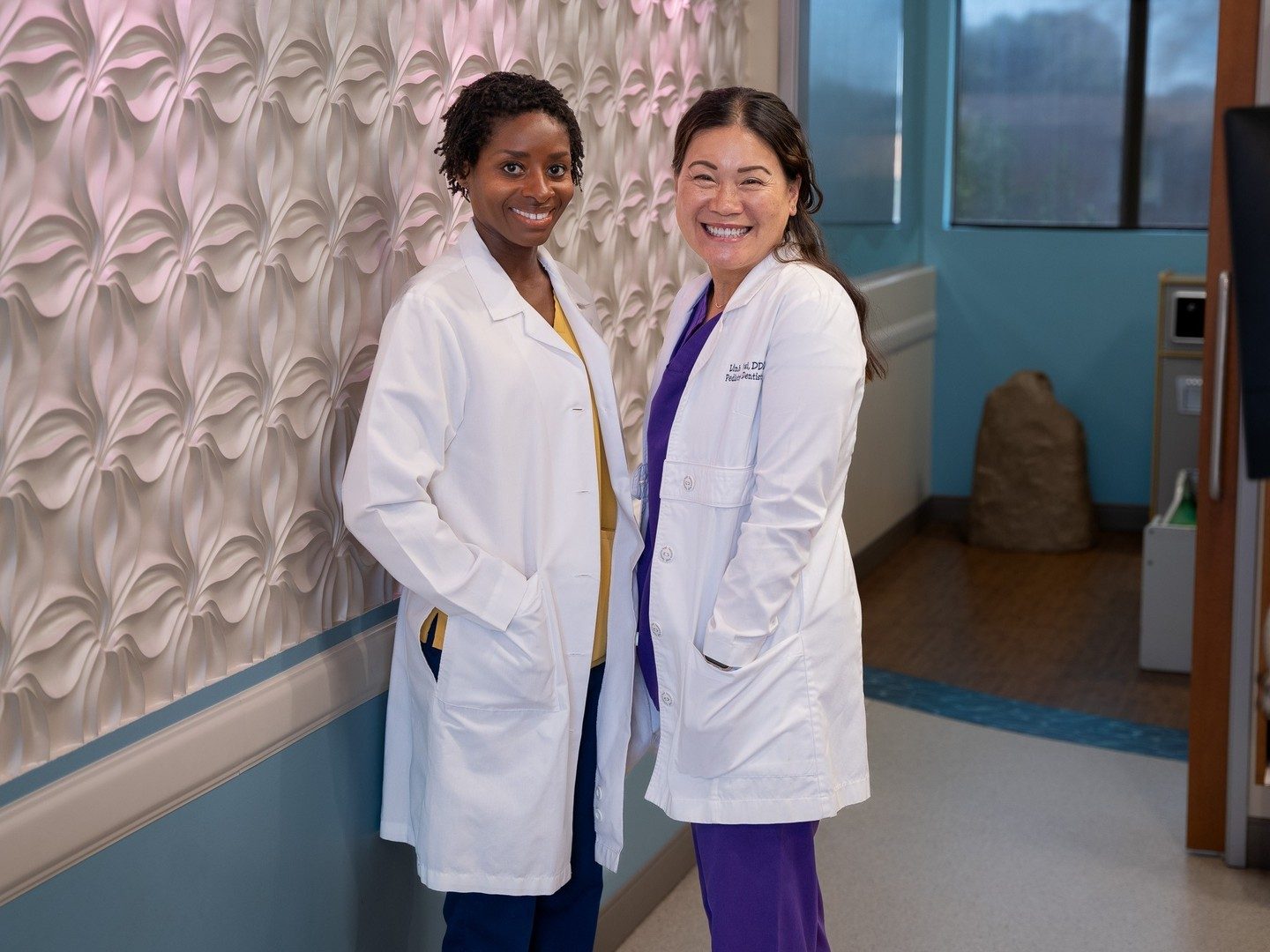 Dr. Judy Brown and Dr. Linh Tsai together in the hallway at the practice